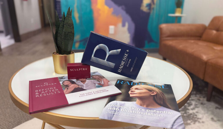 biostimulator Sculptra and Radiesse boxes sitting on a table at Radiant Aesthetics